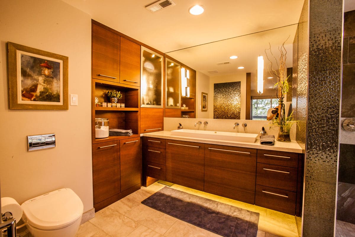 master bathroom with floating vanity cabinets lights in mirror and under the cabinets.