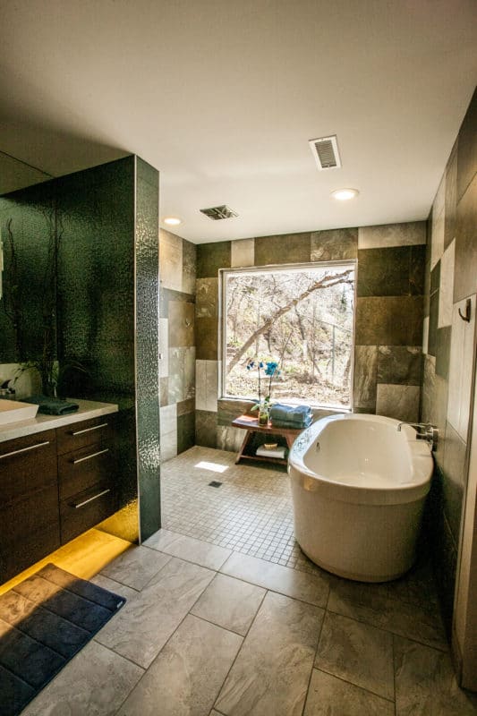 master bathroom with large picture window and stand alone tub