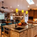 Large kitchen with a spacious island in the center. on the right there are cabinets