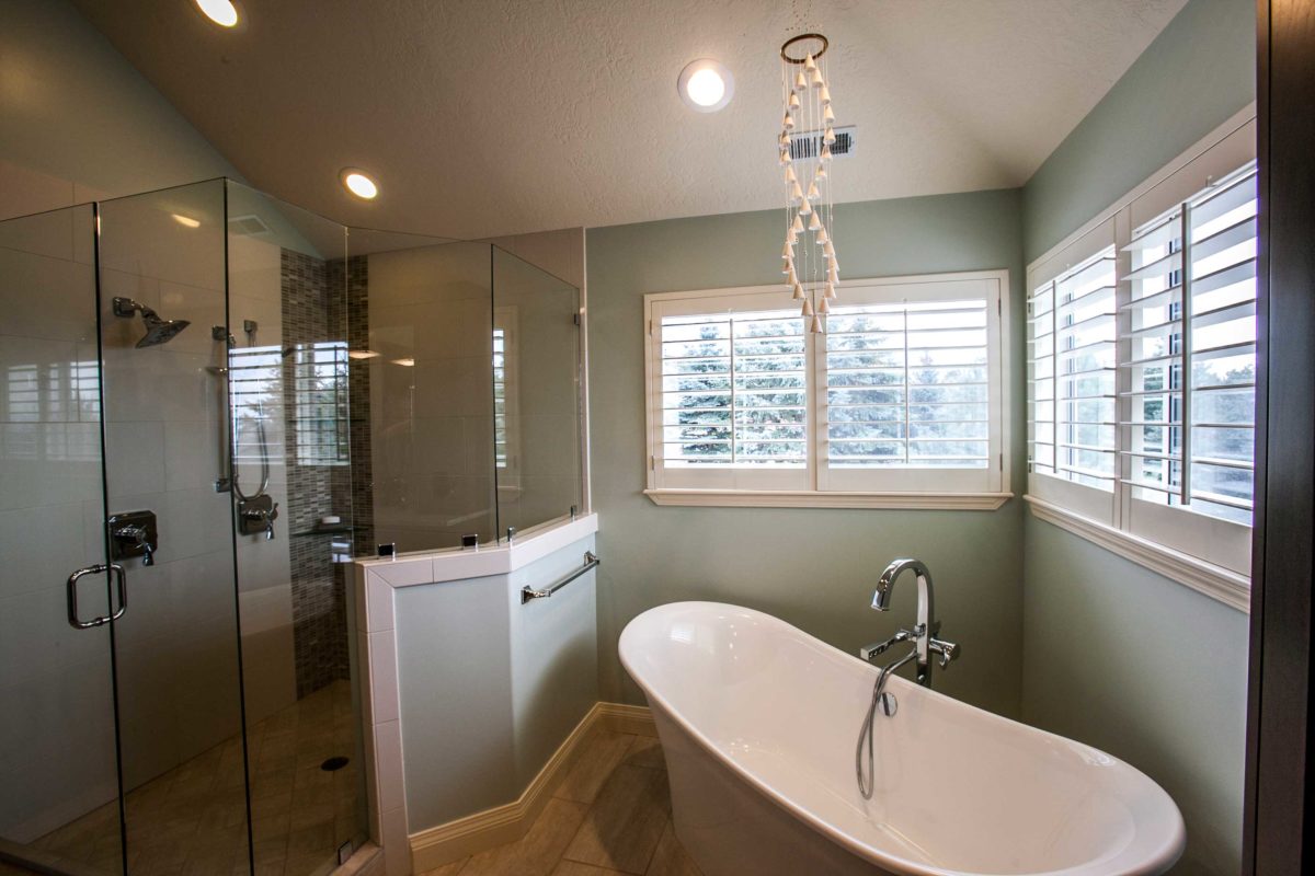 mint green bathroom with tub on right and shower on the left