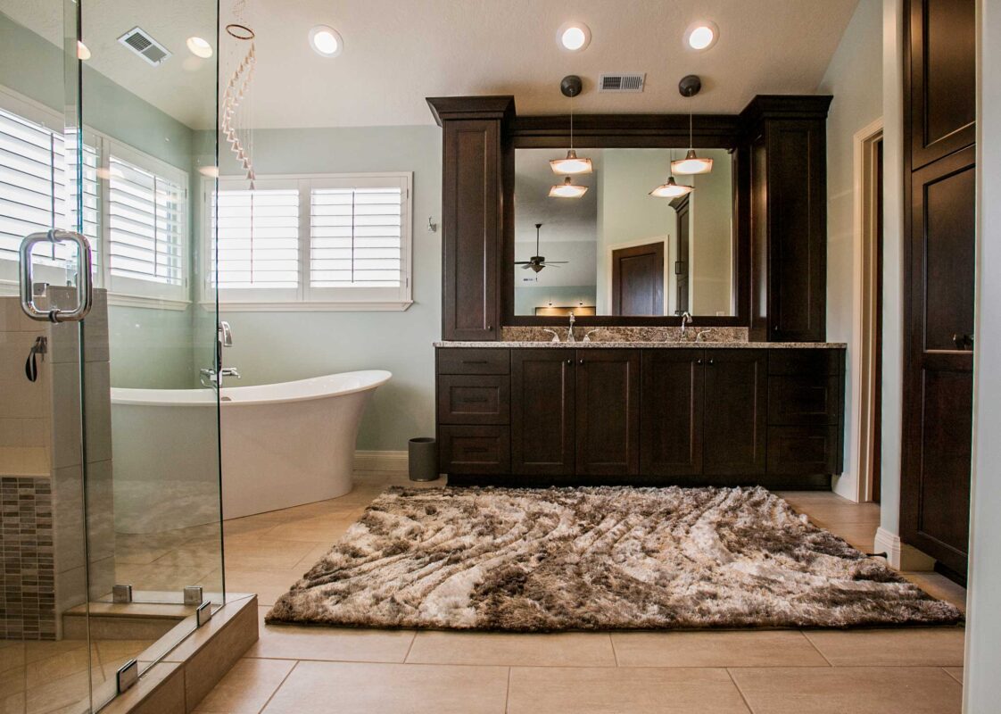 A Large Master Bath with a bathtub on the left and cabinets with a double sink