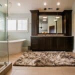 A Large Master Bath with a bathtub on the left and cabinets with a double sink