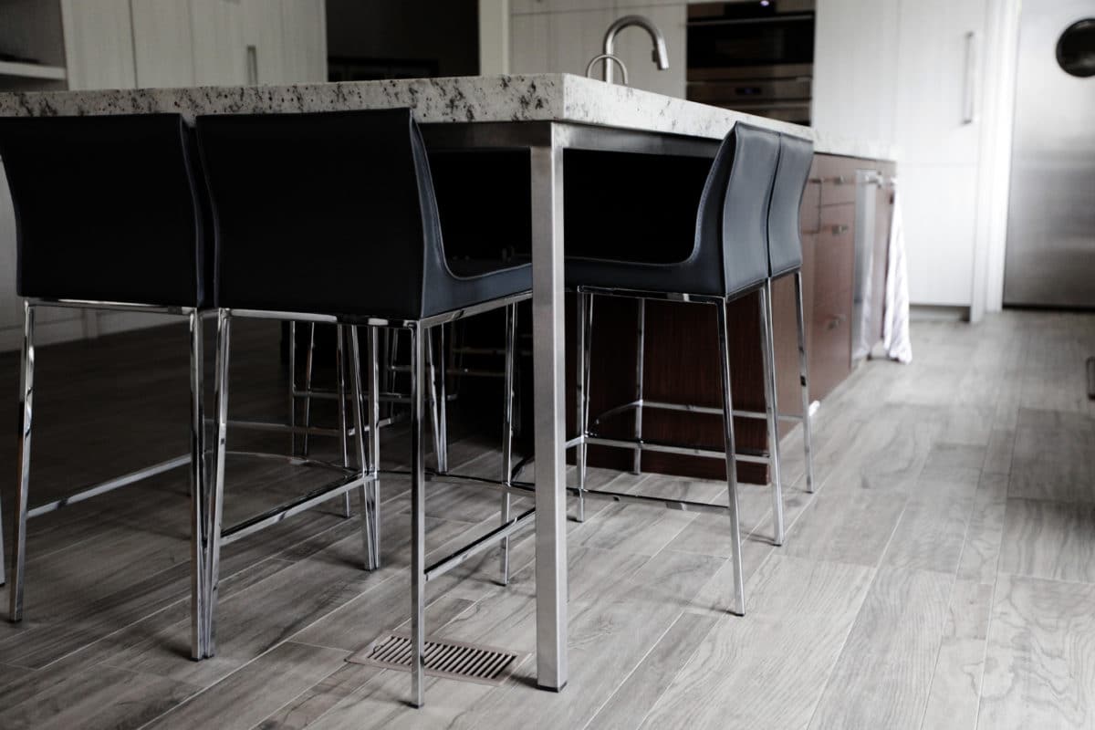 closeup of the island with black and silver barstools