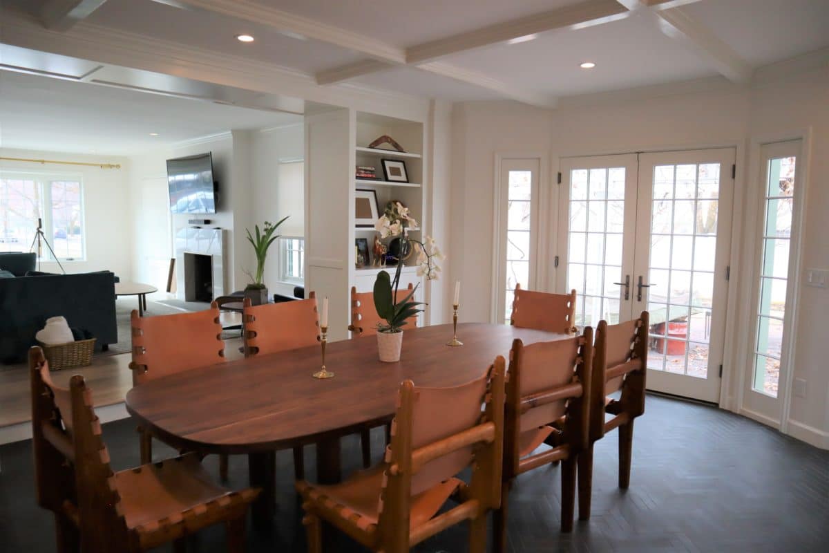 remodeled dining and living room bookcases on the sides of the doorway leather dining room chairs and dining room table