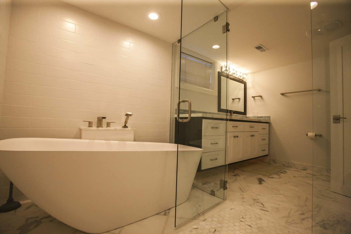 Large shower with bathtub inside shower walls.