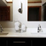 Bathroom counter with double sinks and silver hardware