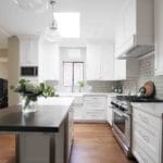 white cabinets in kitchen with white and dark island