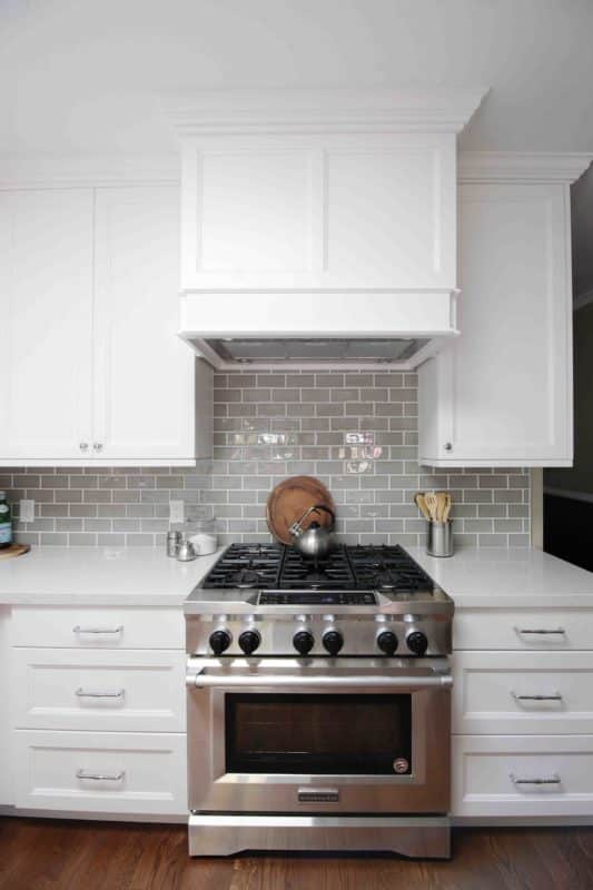 white cabinetry with silver stove