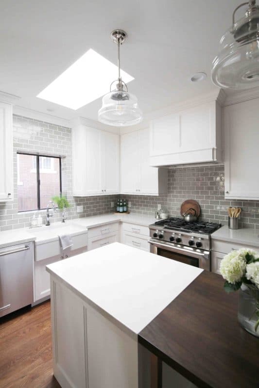remodeled kitchen, white cabinetry with island and stove. Skylight above kitchen sink