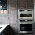 wood cabinets surrounding a silver oven.