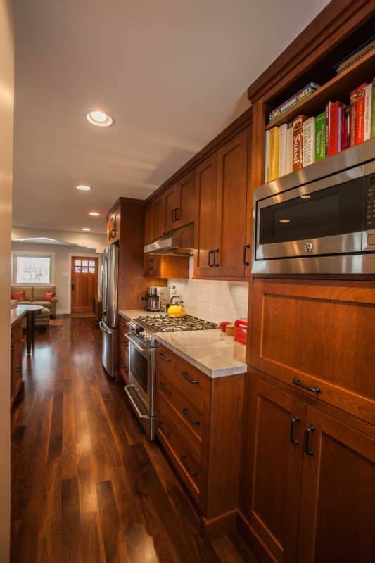 kitchen with wood cabinetry and silver microwave