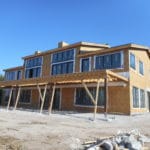 back view of framed new home build with windows installed