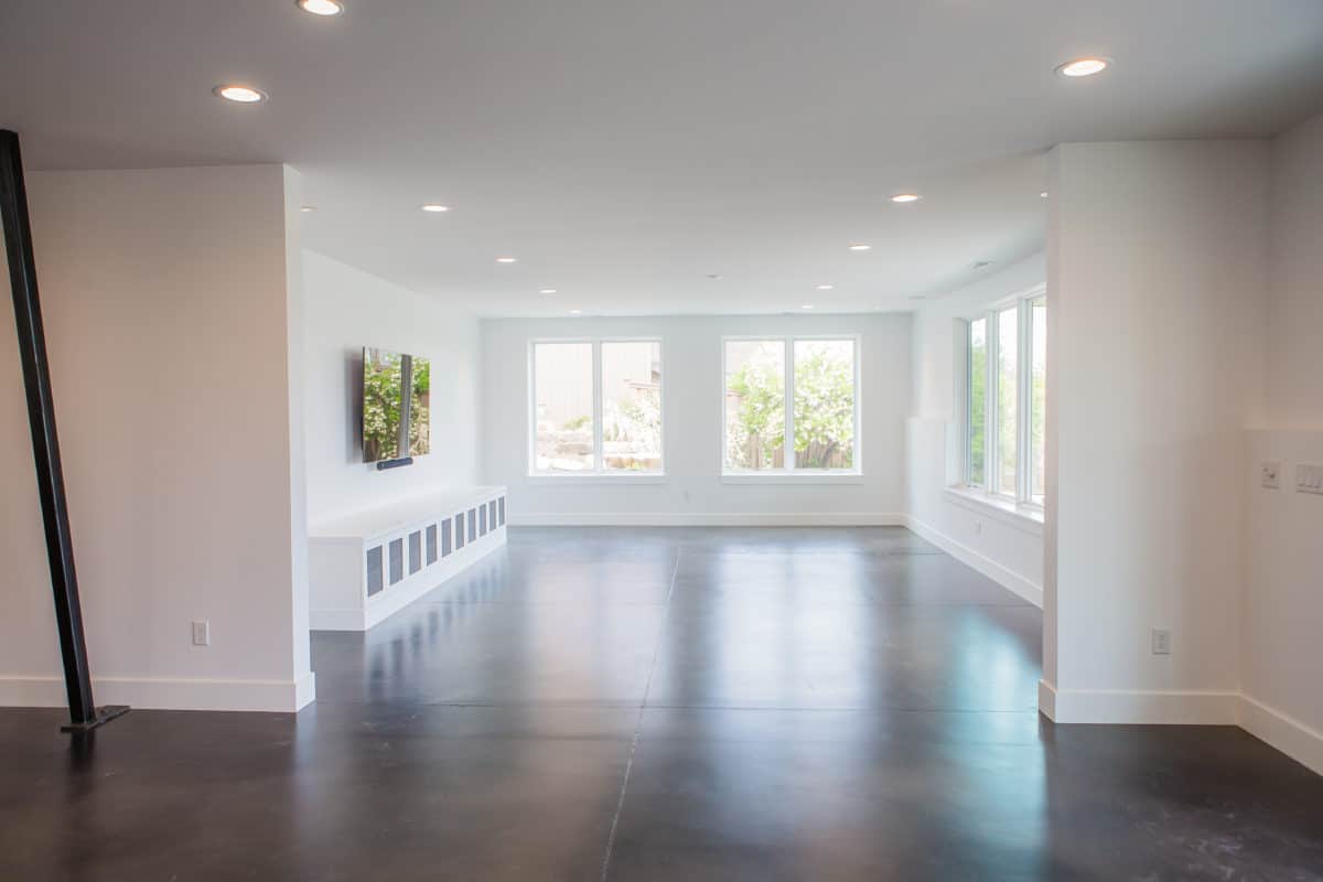 daylight basement with polished concrete floors large windows and built in cubbies