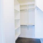 closet organizers in basement closet of luxury new home build