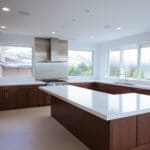 dark cabinets and white countertops with stainless appliances in premier home build