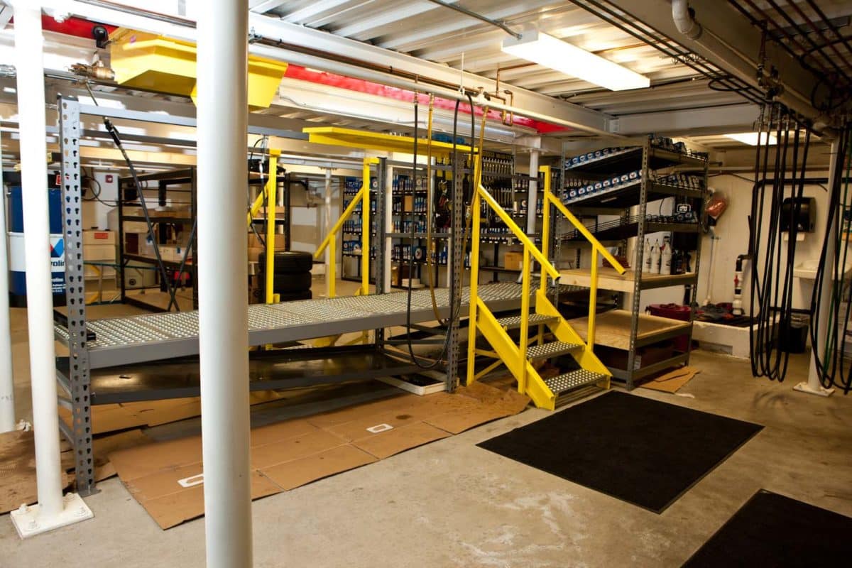 lube bay of the oil changing bay in a tire store, yellow metal stairs to platform