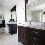 dark bathroom cabinets, two vanities, mirrors framed in wood