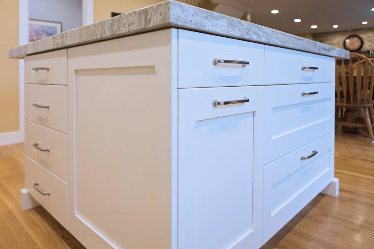 white kitchen cabinets, shaker style with light colored countertop