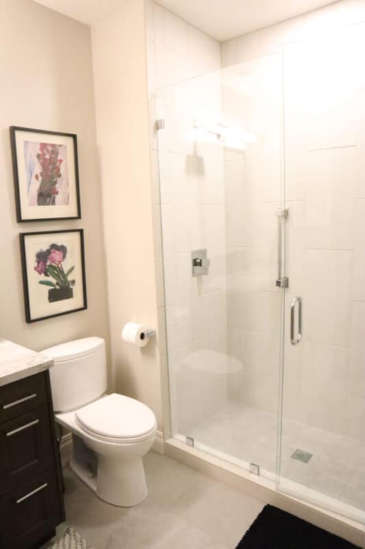 Contemporary bathroom design with walk-in shower and white shower titling by Fine Remodel